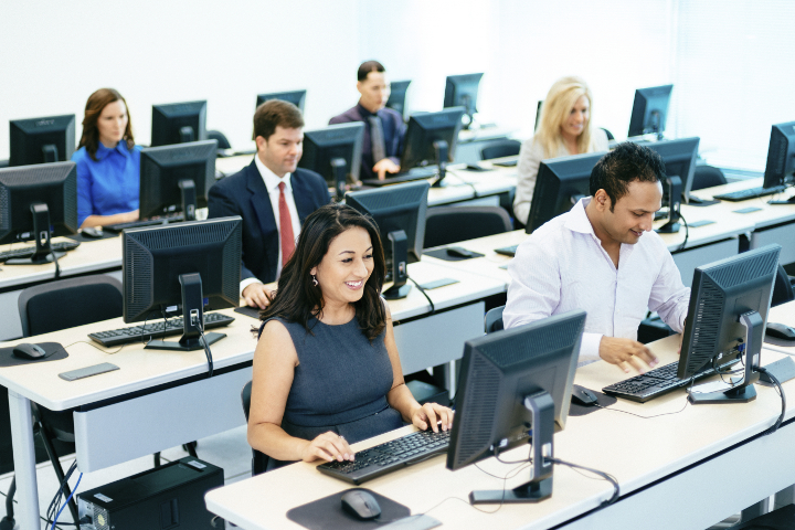 stock photo of happy people working in an office on computers