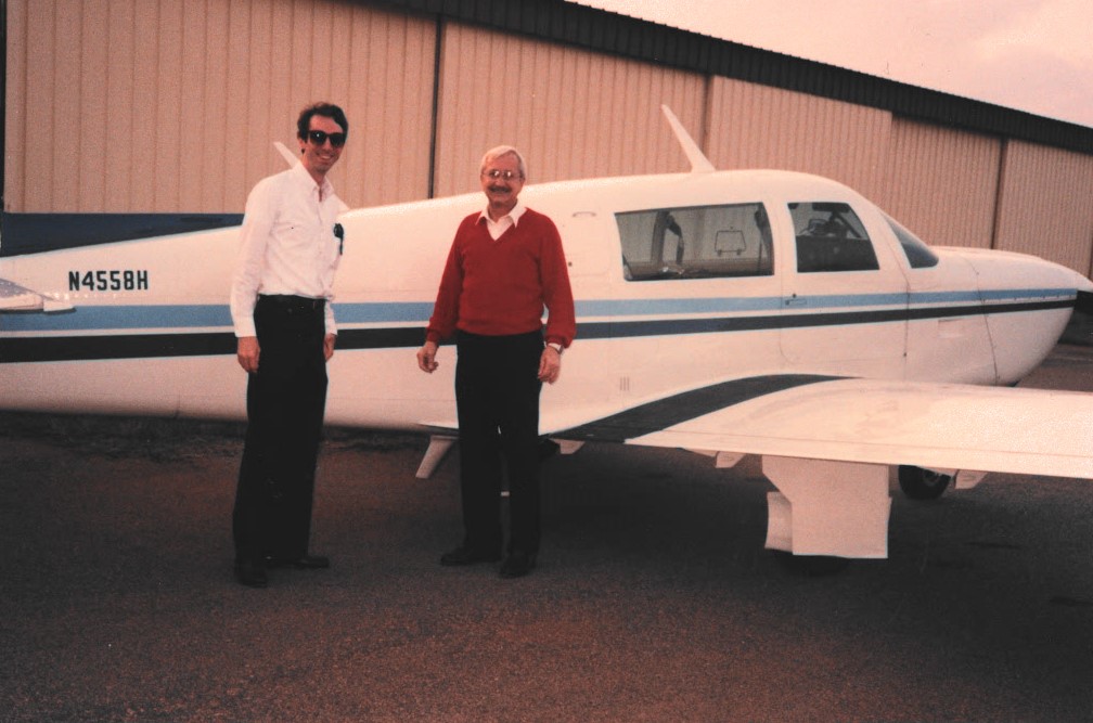 Dr. Thomas in front of his plane he enjoyed flying