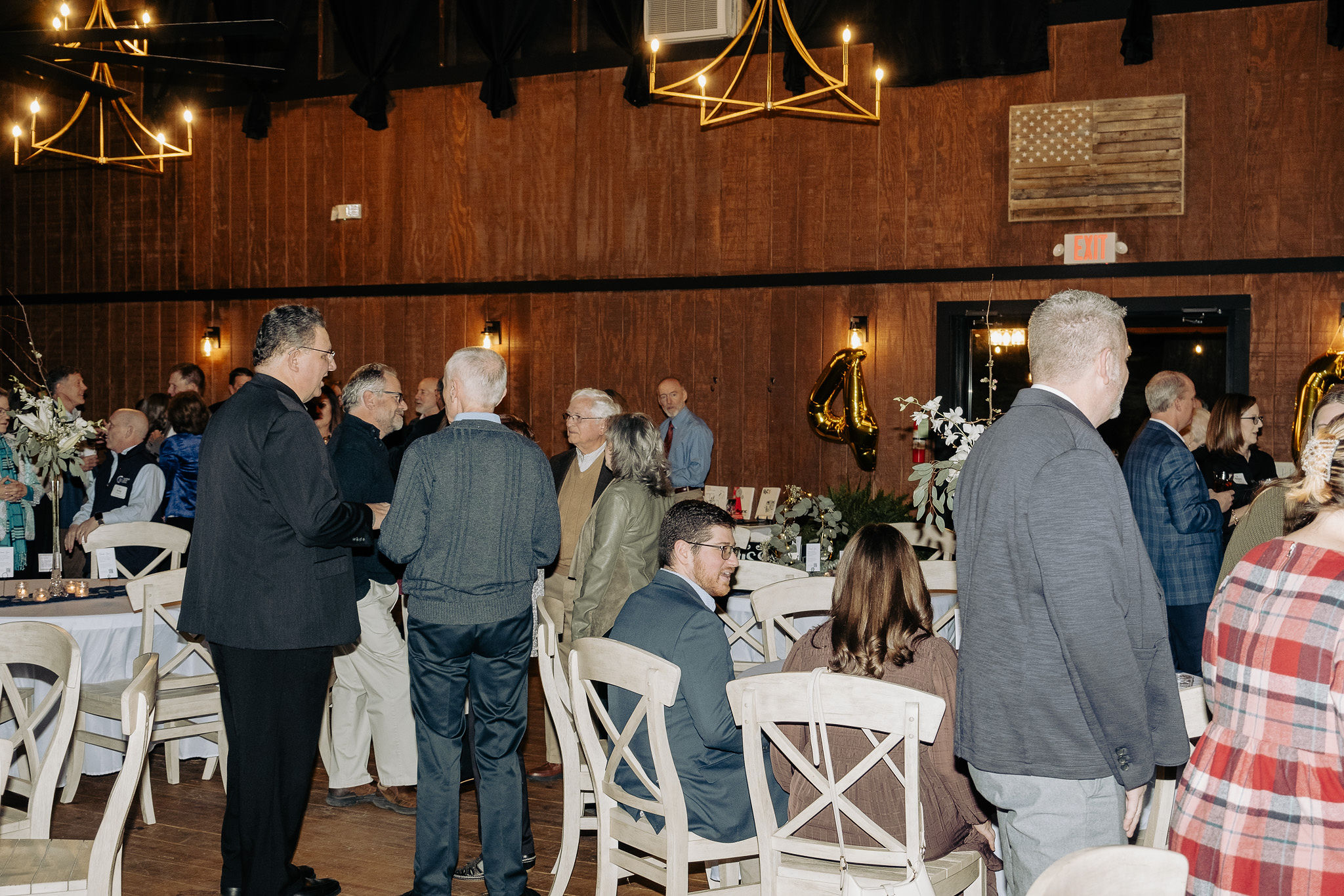 guests at ISS' 40th celebration chatting around tables